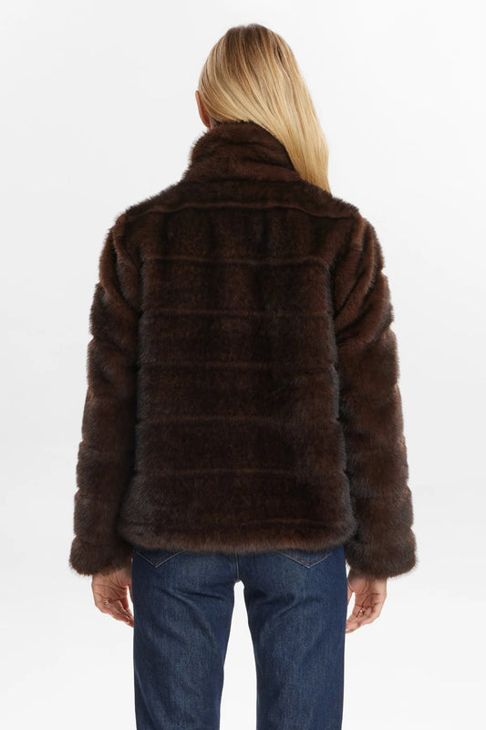 Brown fur jacket worn by a person on a white background