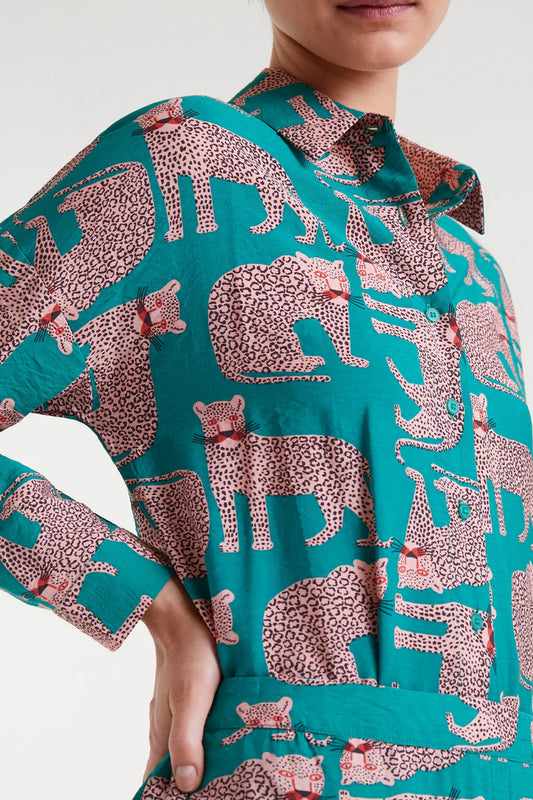 Teal shirt with pink animal pattern worn by a person