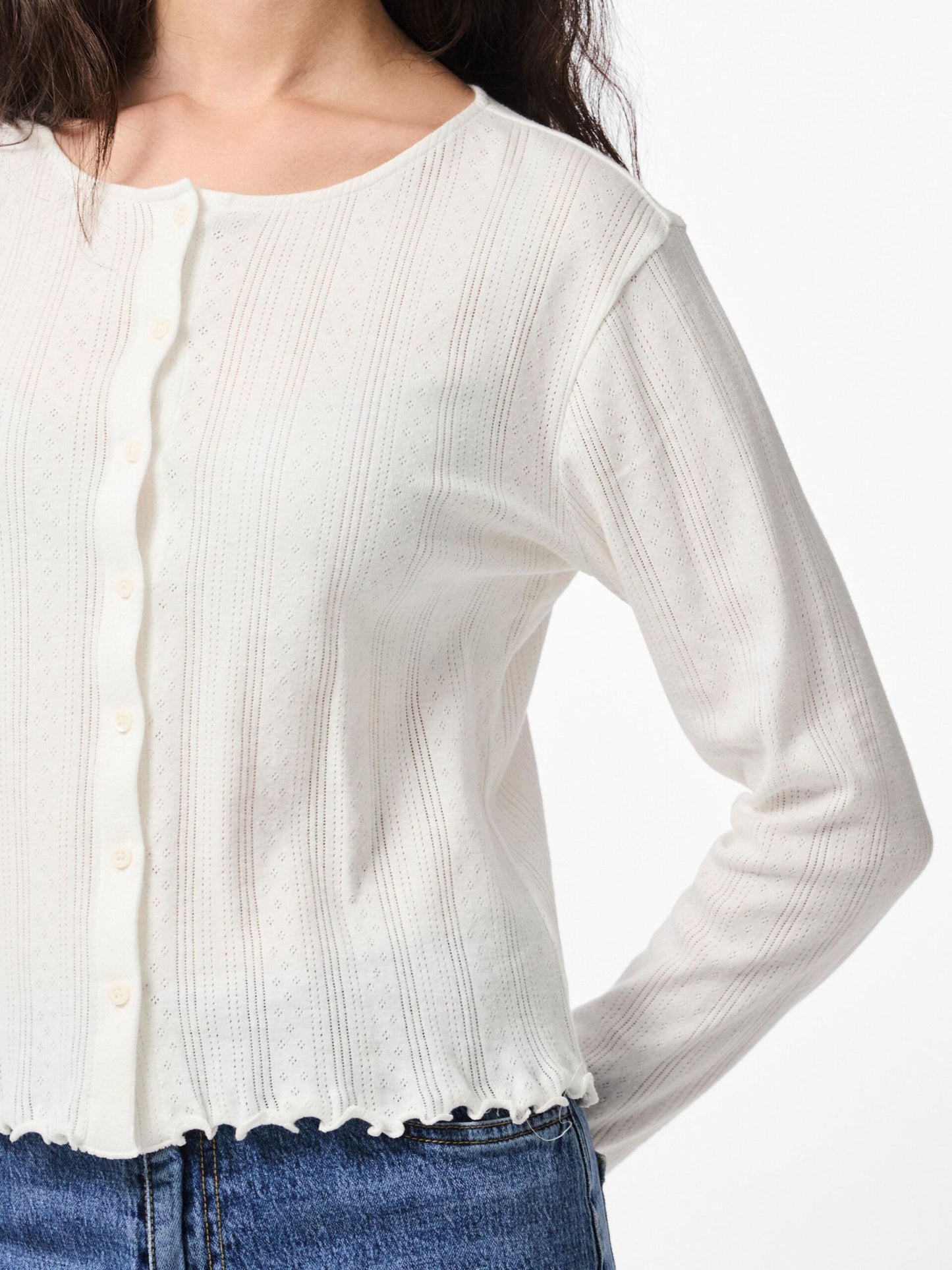 White long-sleeve top worn by a person on a white background
