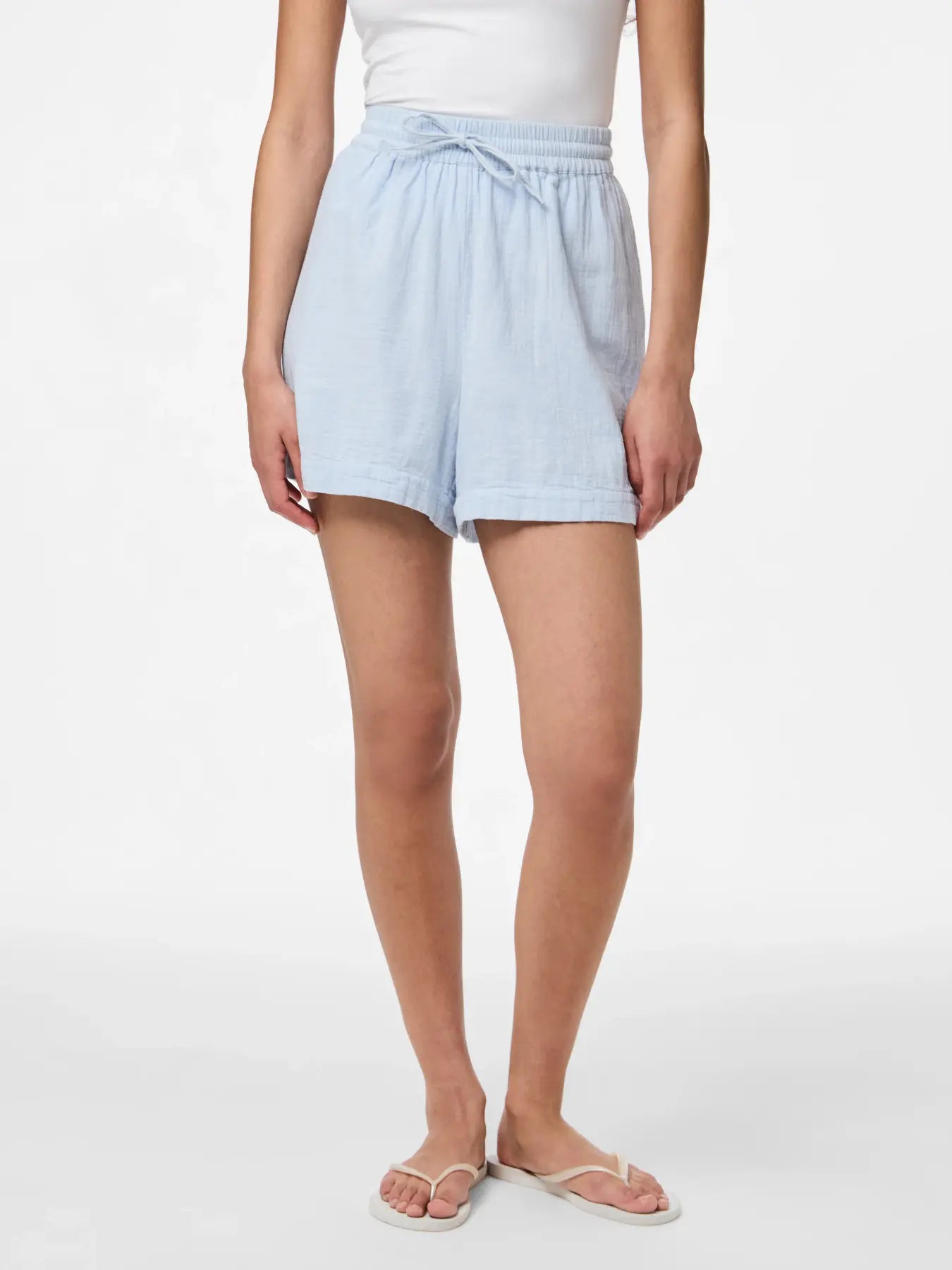 Light blue shorts worn by a person on a white background