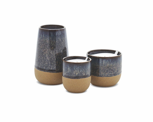 Three ceramic candles with a dark gray top and beige base on a white background