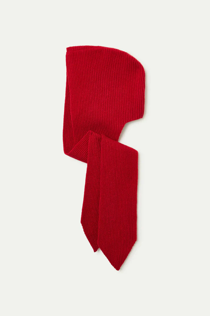 Red knitted headband with a bow on a white background