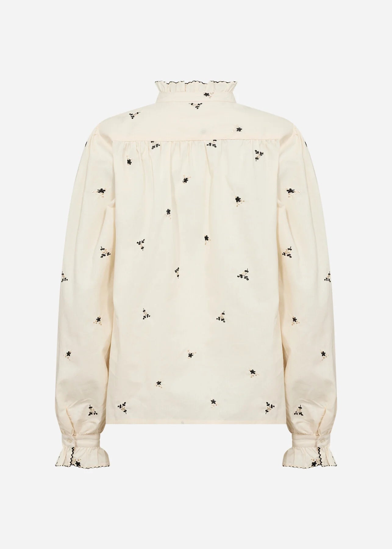 White blouse with black floral patterns on a white background