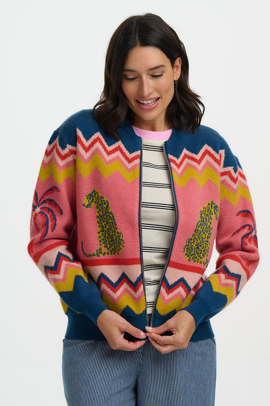Woman wearing a colorful patterned cardigan on a white background