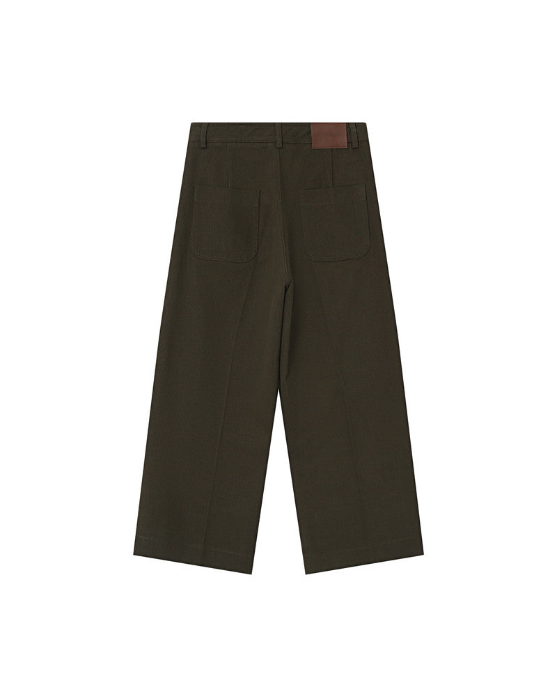 Dark green pants with a brown patch on a white background