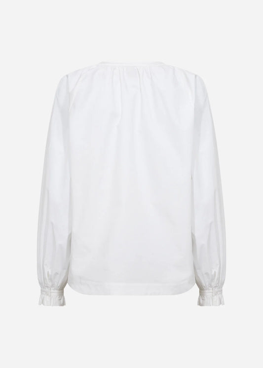 White blouse with balloon sleeves on a light gray background