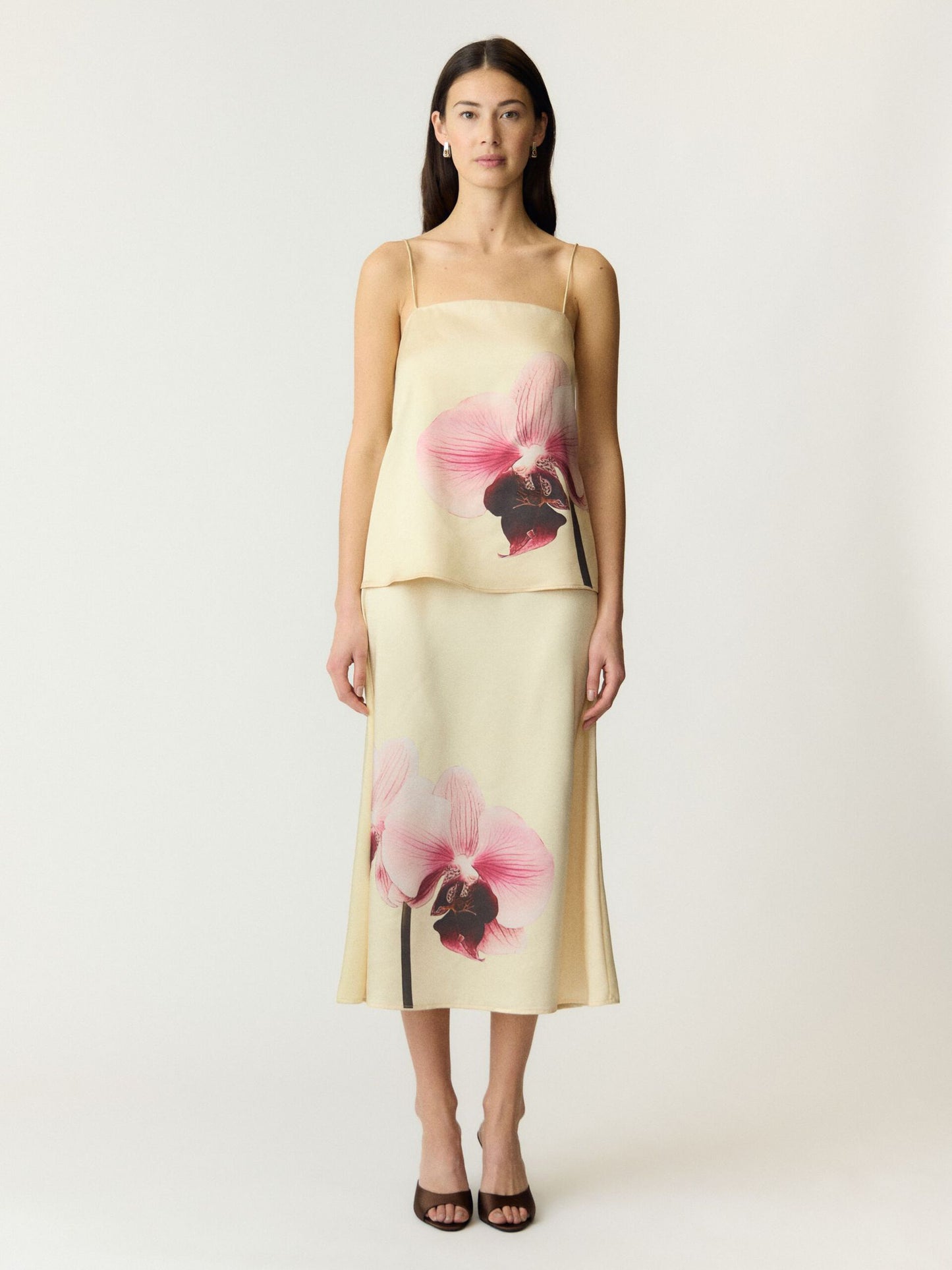 Pale yellow strappy top and skirt with pink floral print on a white background