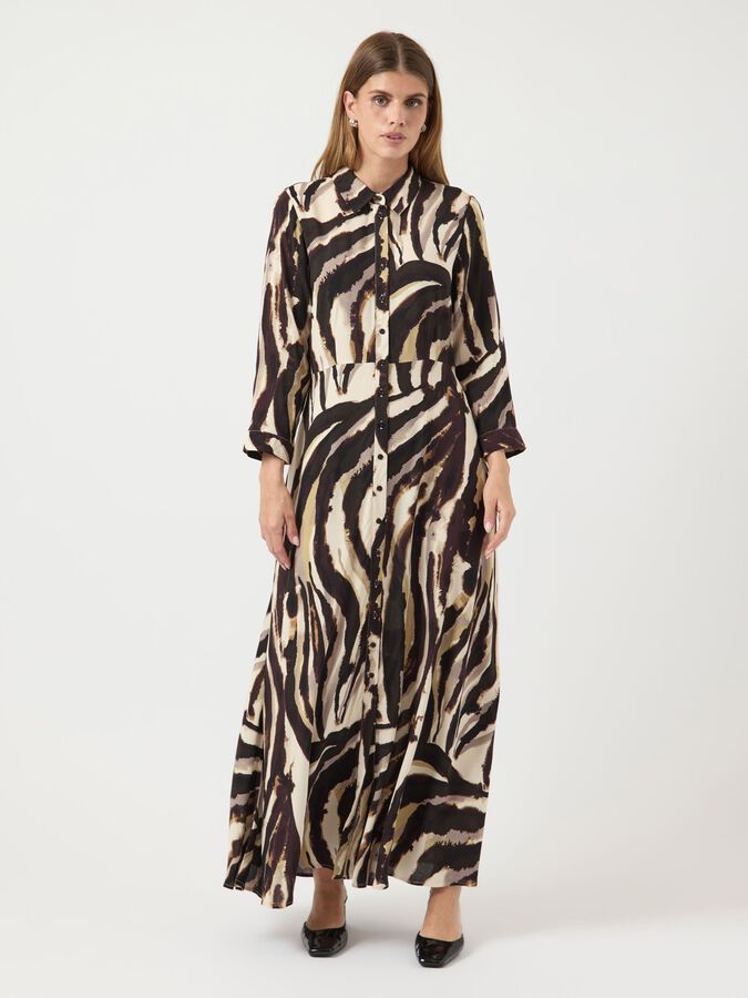 Woman wearing a zebra print dress on a white background