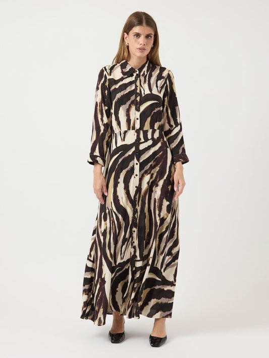 Woman wearing a zebra print dress on a white background
