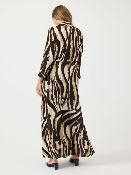 Woman wearing a zebra print dress on a white background