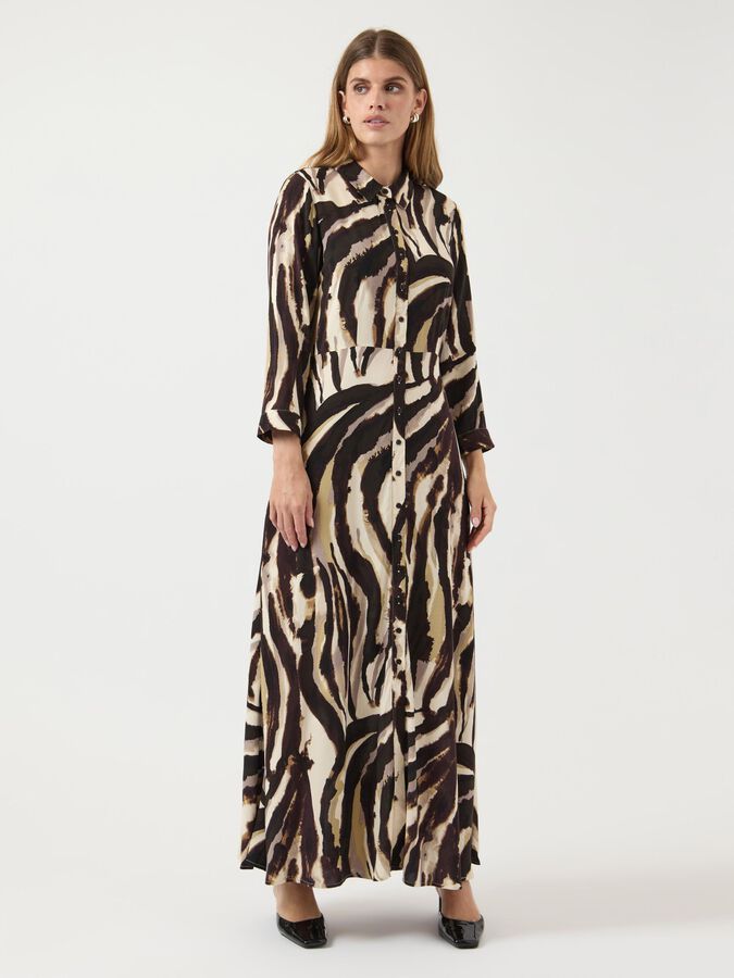Woman wearing a zebra print dress on a white background