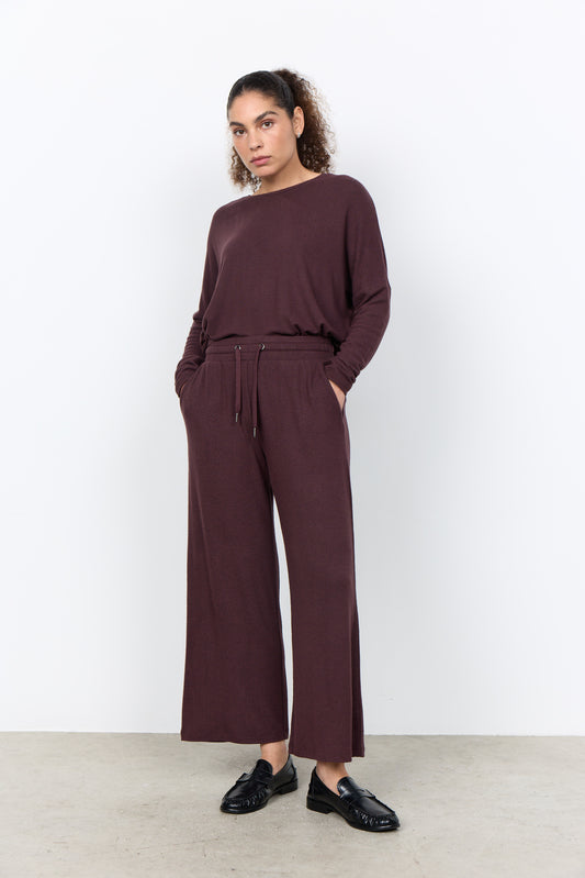 A pair of wide-leg trousers in a heathered dark plum or burgundy-brown fabric, shown flat against a solid white background.
