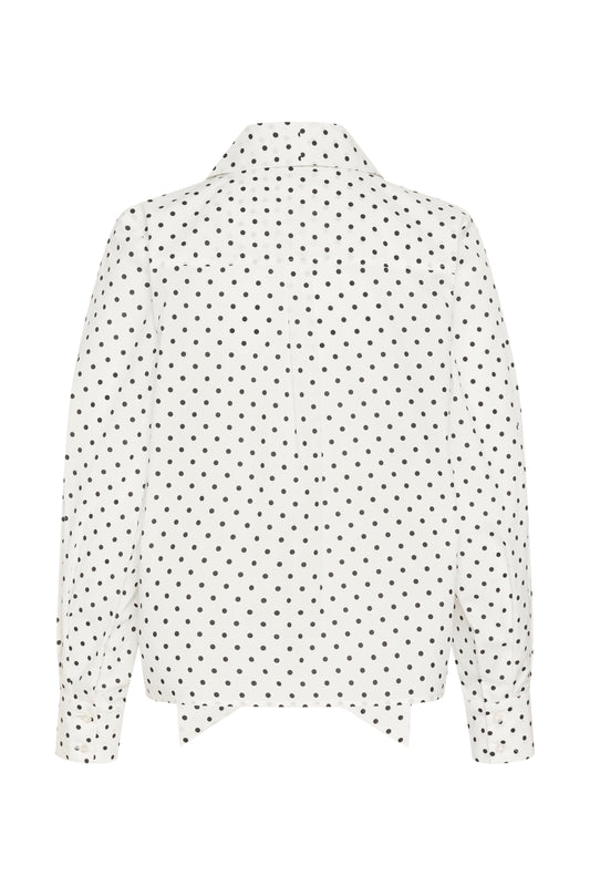 A white long-sleeve blouse with a black polka dot pattern, shown from the back against a plain white background.