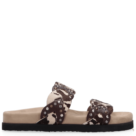 Beige sandal with decorative straps on a white background