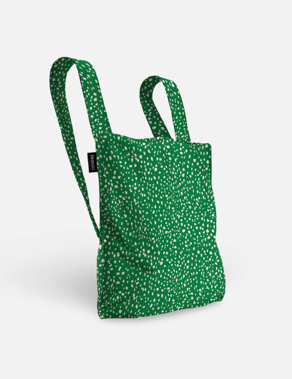 Green spot-patterned backpack on a white background