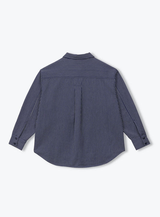 A dark slate blue long-sleeve button-down shirt shown from the back, featuring a subtle vertical texture and a curved hem, displayed on a clean white background.
