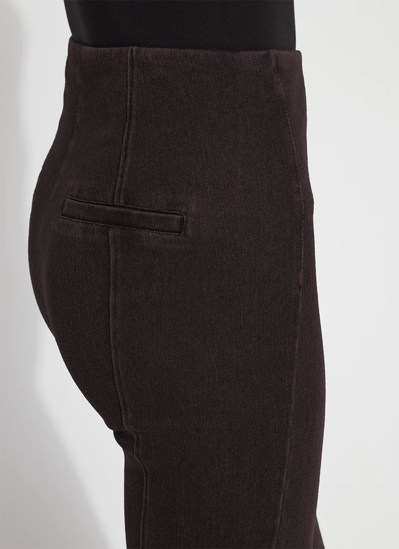 Close-up side view of a person wearing dark brown corduroy trousers, showing the side pocket and fabric texture against a light gray background.