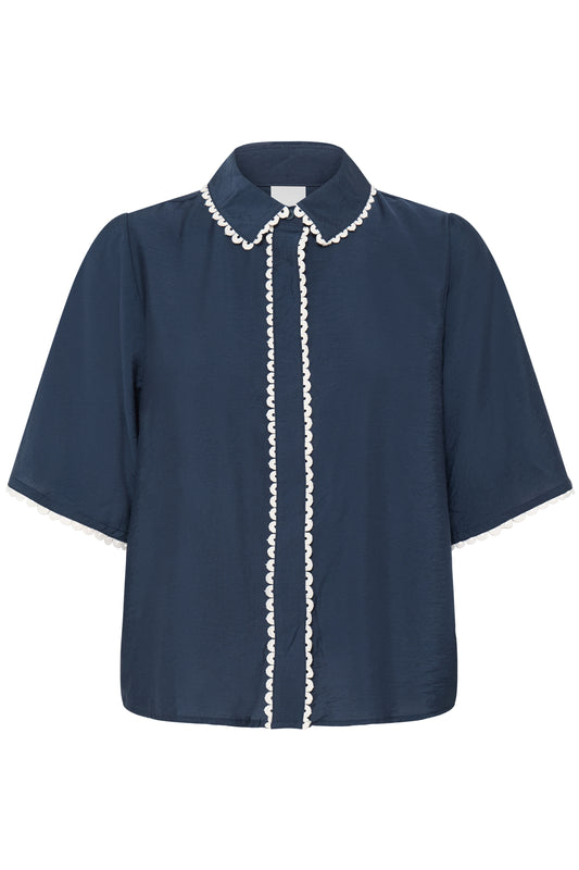 Navy blue blouse with white trim on a white background