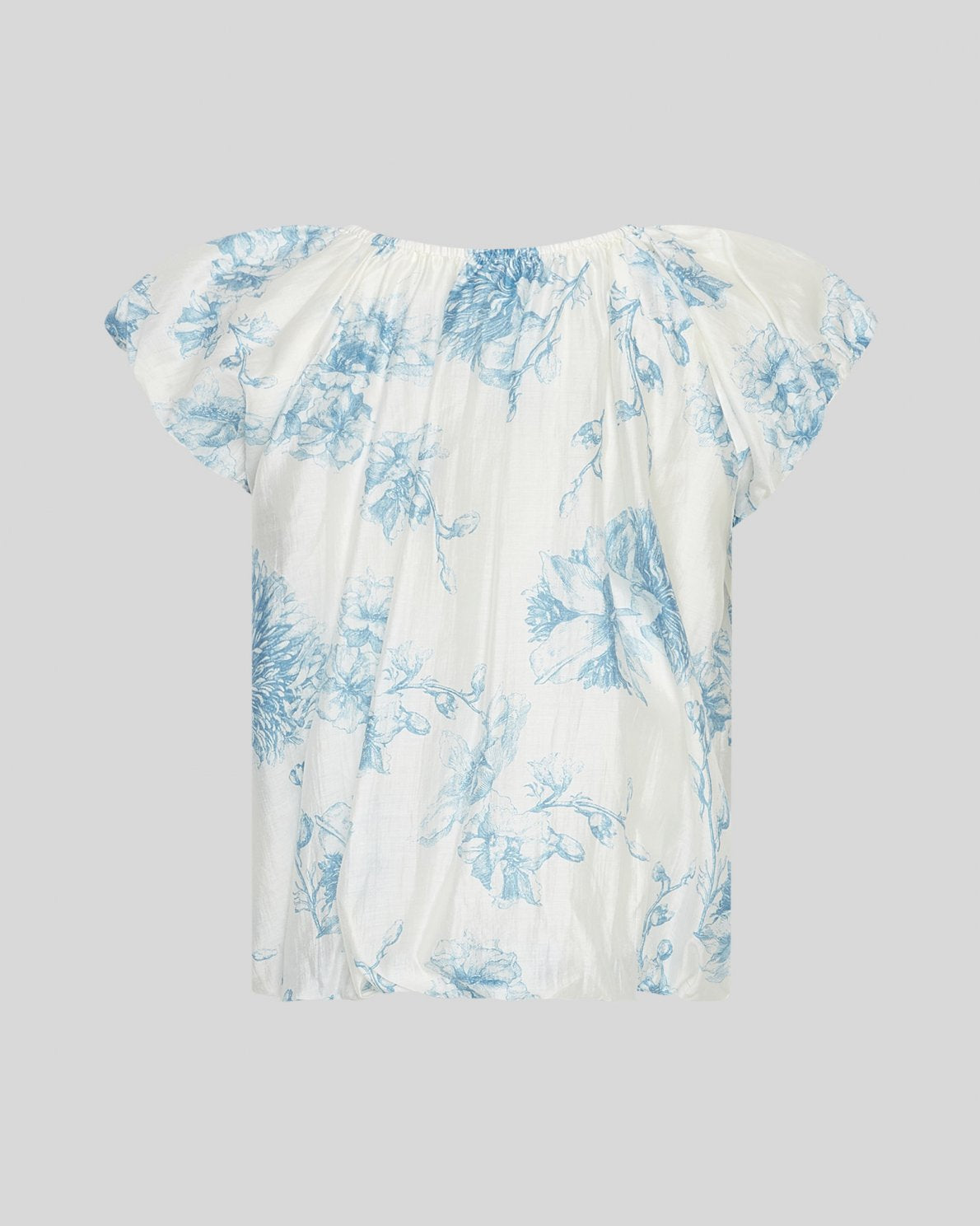 white and blue floral top on a light grey background