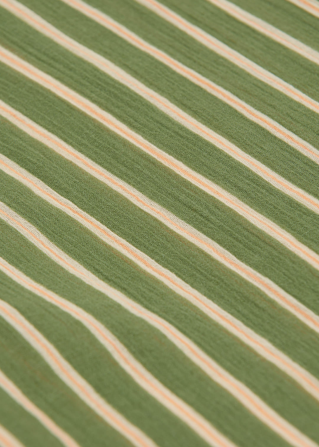 Close-up of green fabric with beige stripes