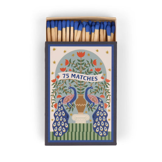Matches in a decorative box with peacock design and floral elements.