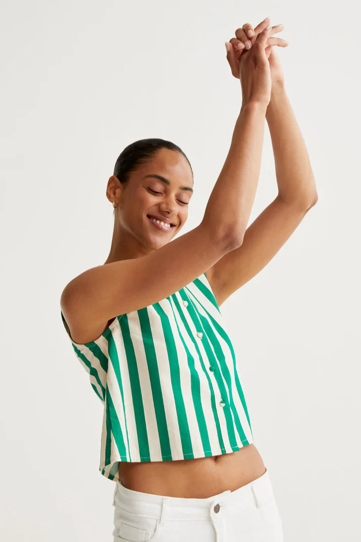 Woman wearing a green and white striped sleeveless top against a plain background