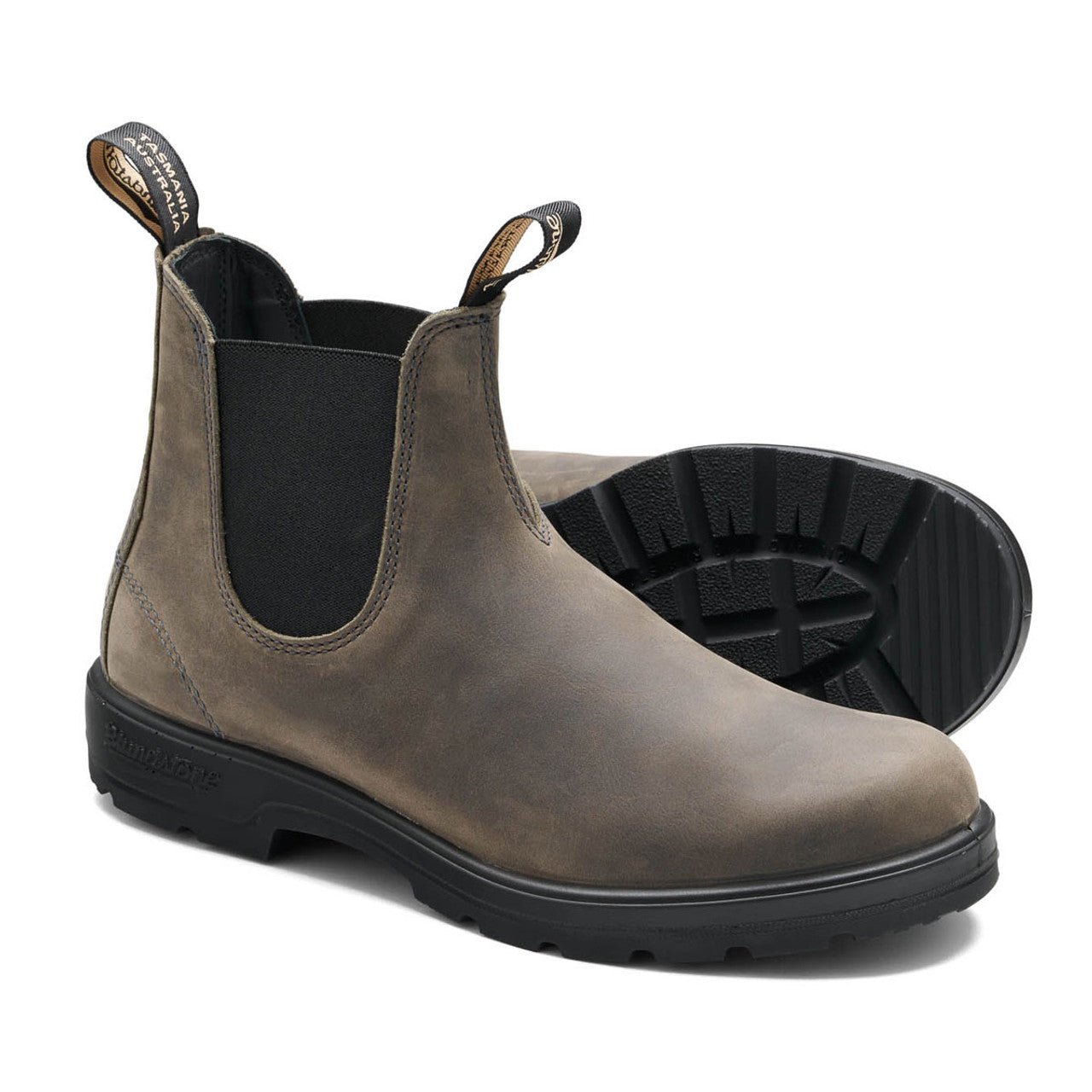 Brown Chelsea boot with black sole on a white background