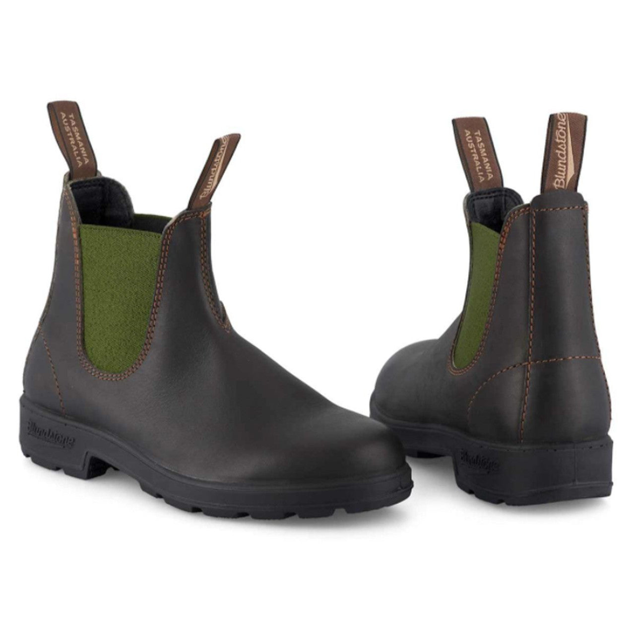 Pair of black rubber boots with green inner lining on a white background