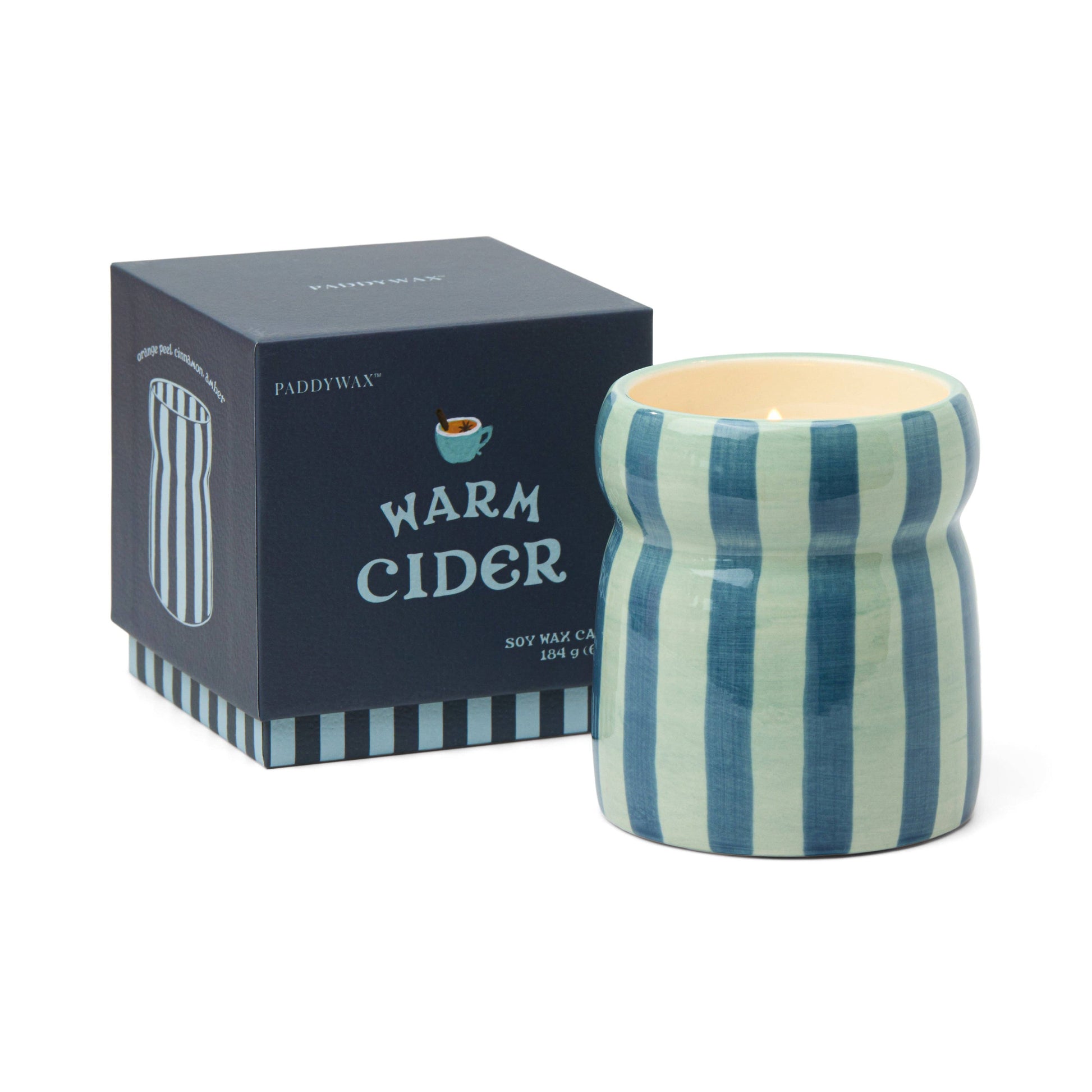 Striped candle with 'Warm Cider' packaging on a white background