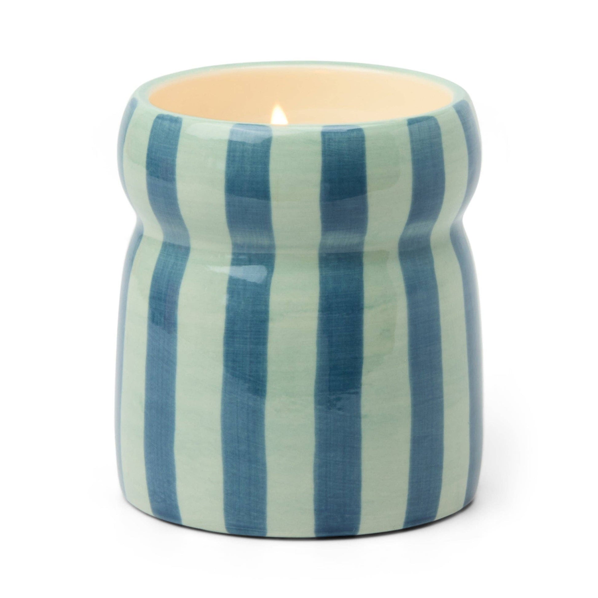Candle in a striped ceramic holder on a white background