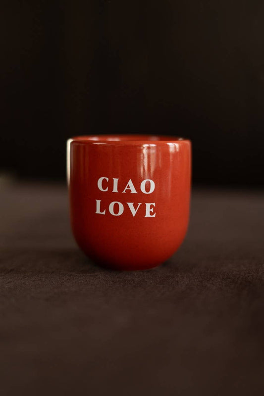 Red mug with 'CIAO LOVE' text on a dark background