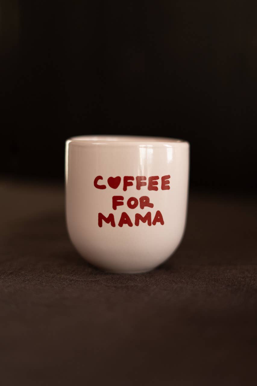 White mug with 'Coffee for Mama' text on a dark background