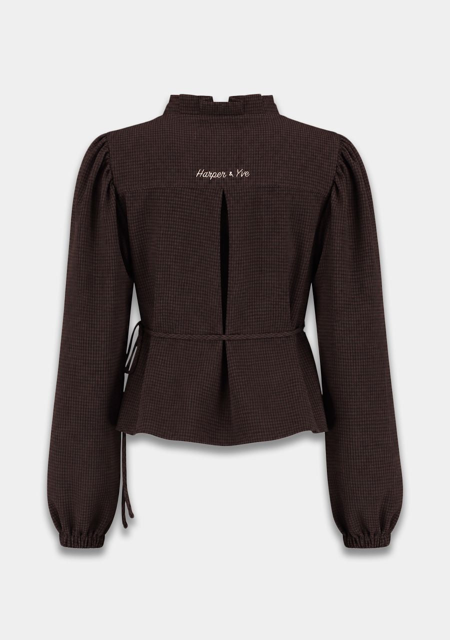 A dark brown textured long-sleeve blouse with a mock neck, puff sleeves, and a drawstring waist, shown from the back on a light gray background.