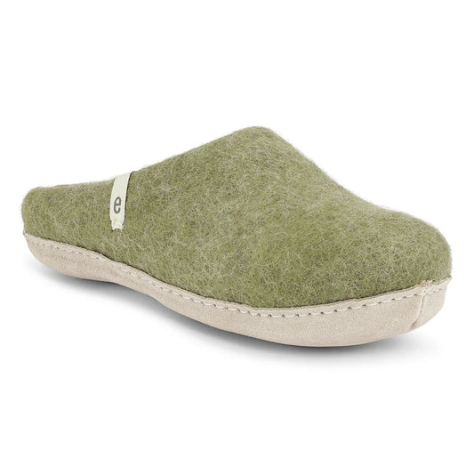 Green slipper with beige sole on a white background