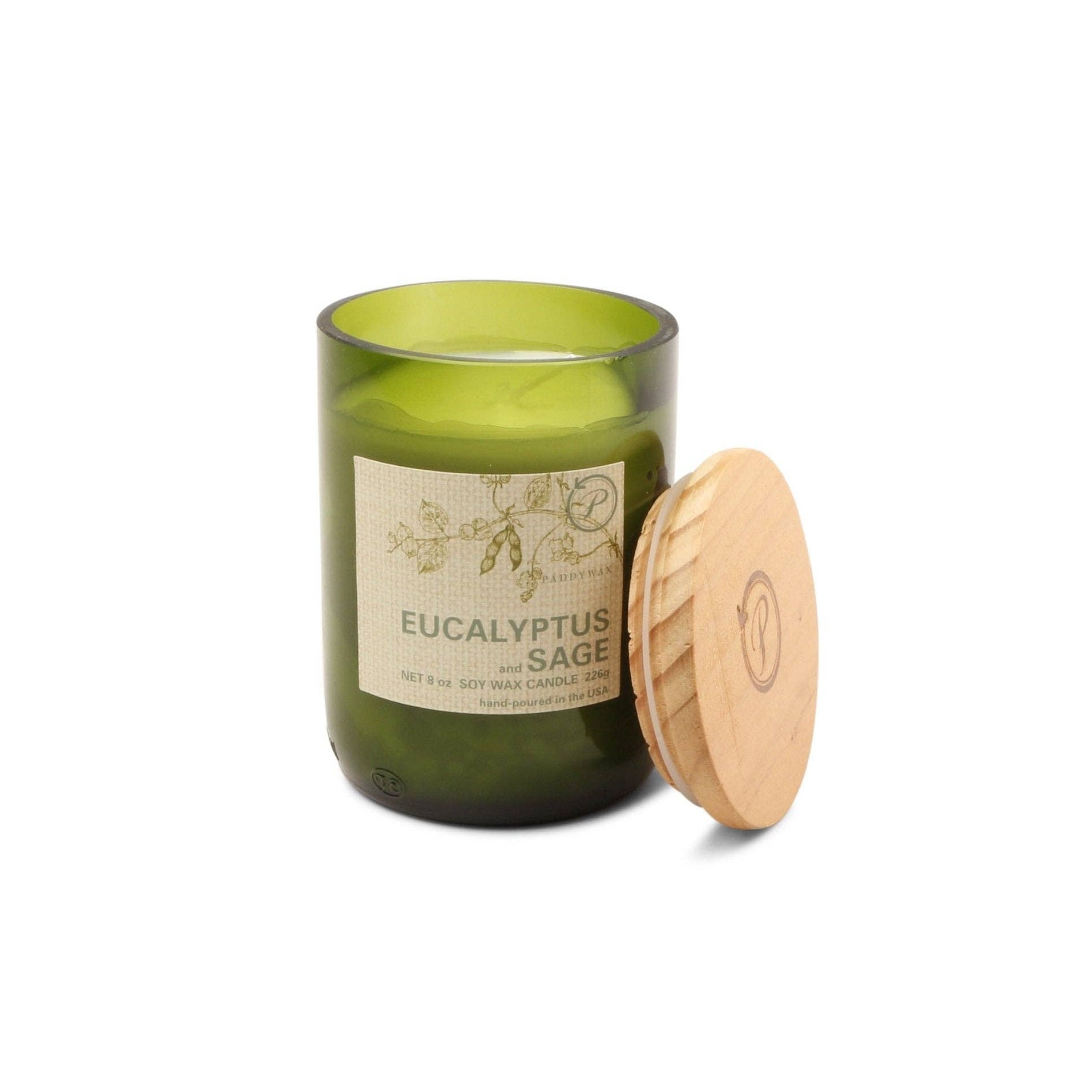 Green candle with wooden lid on a white background