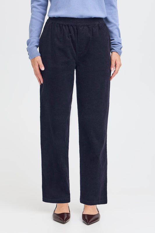 Person wearing navy pants on a white background