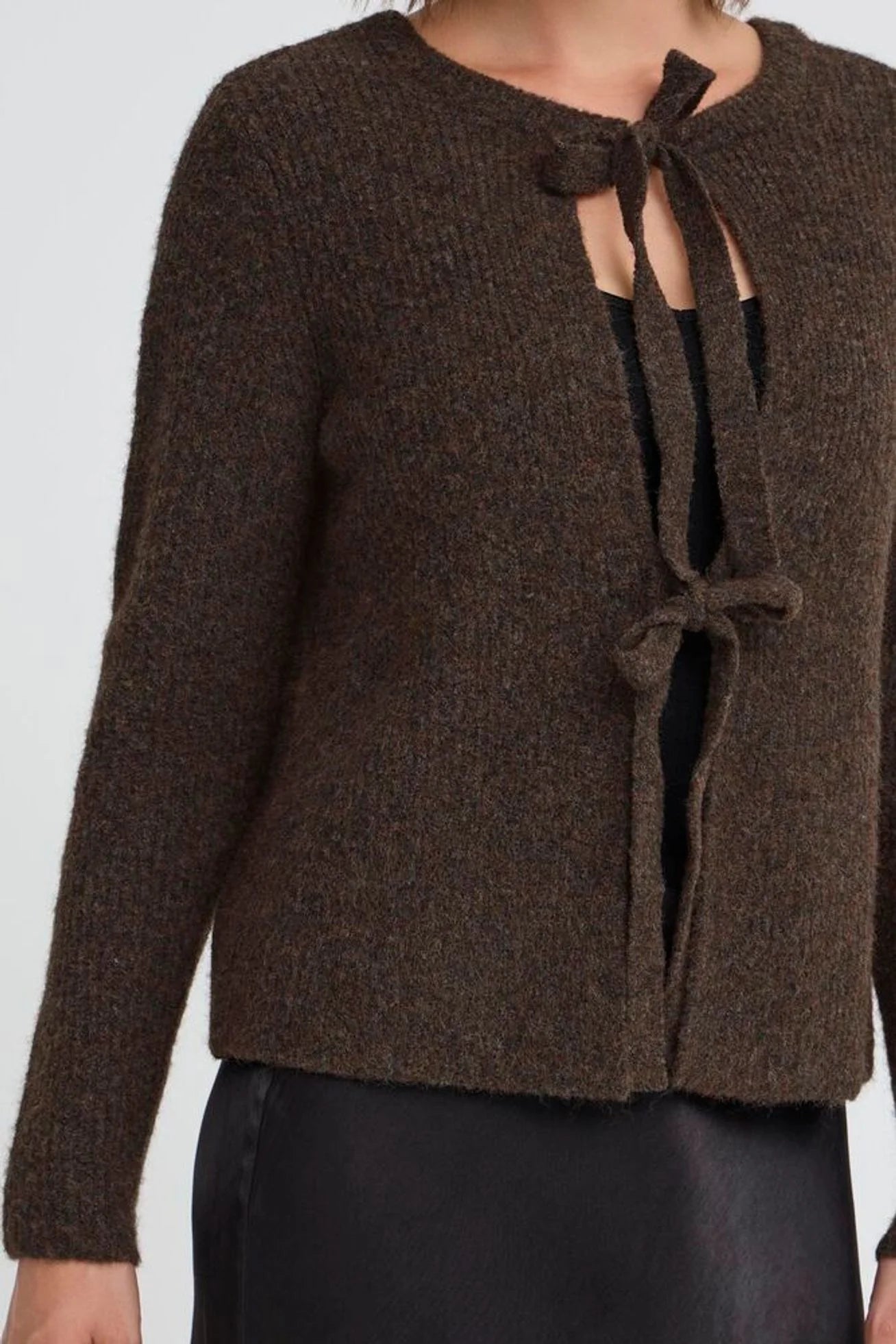 Brown knitted cardigan with tie details on a white background