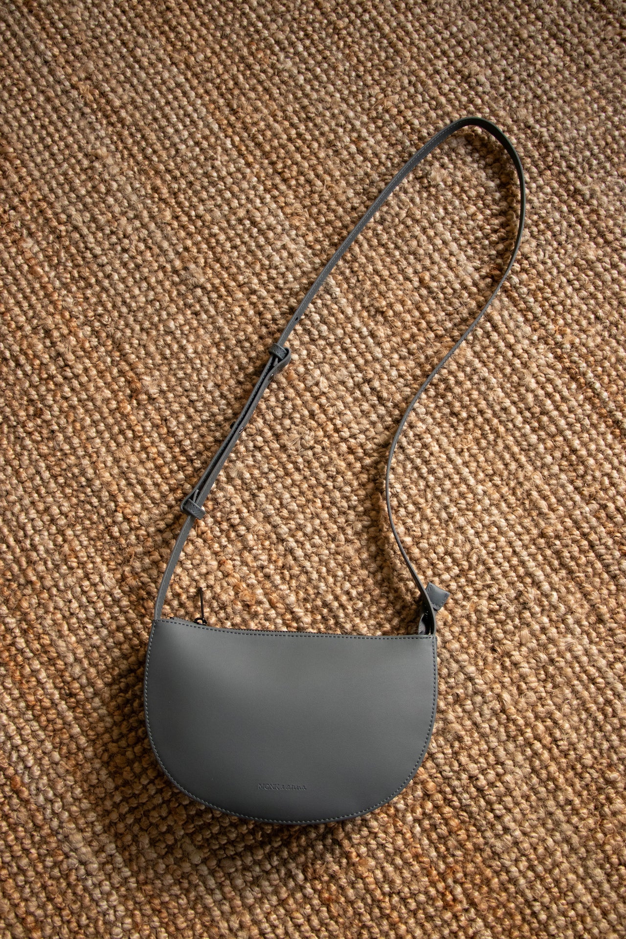 blue grey handbag on a jute rug