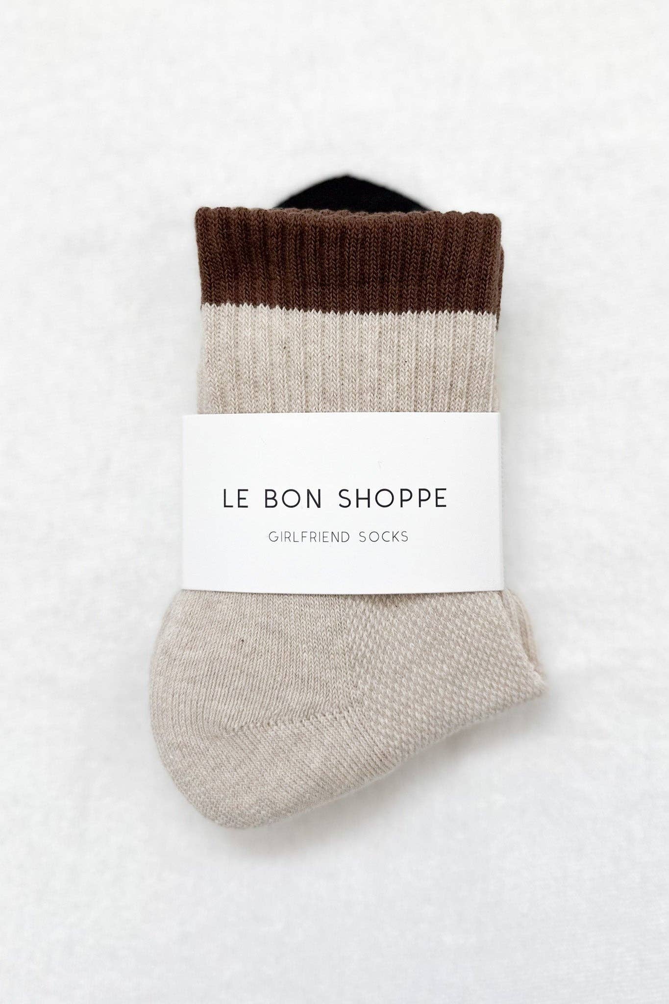 Pair of color-blocked socks with a label on a white background