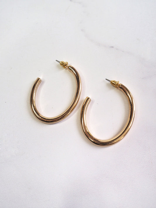 Gold hoop earrings on a white background