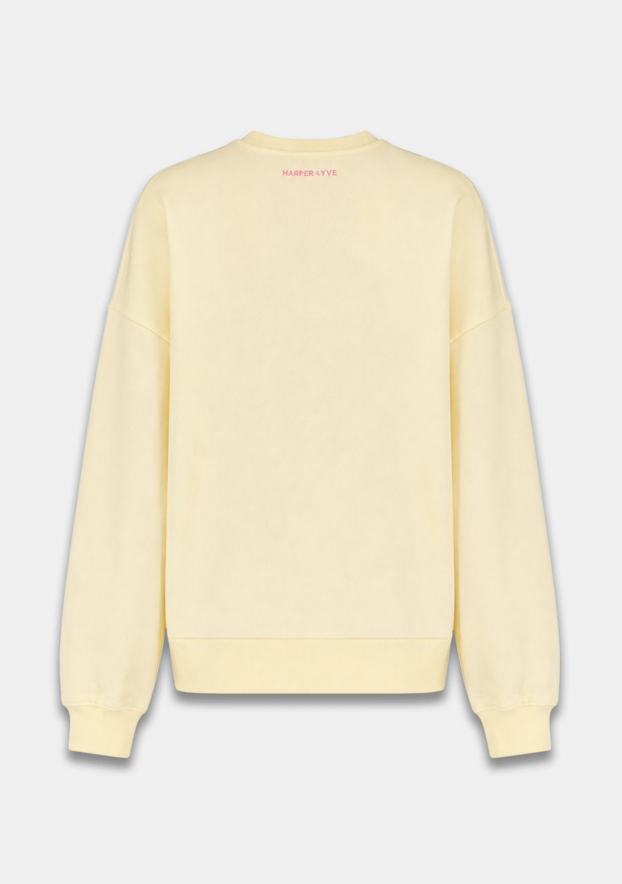 A pale yellow crewneck sweatshirt shown from the back, featuring a small pink 'SWEATERS-OUTLET' logo printed at the inner neckline, set against a light gray background.