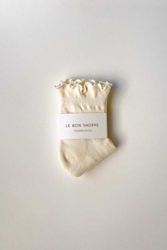 Beige sock with ruffled top on a white background, featuring 'Le Bon Shoppe' branding.