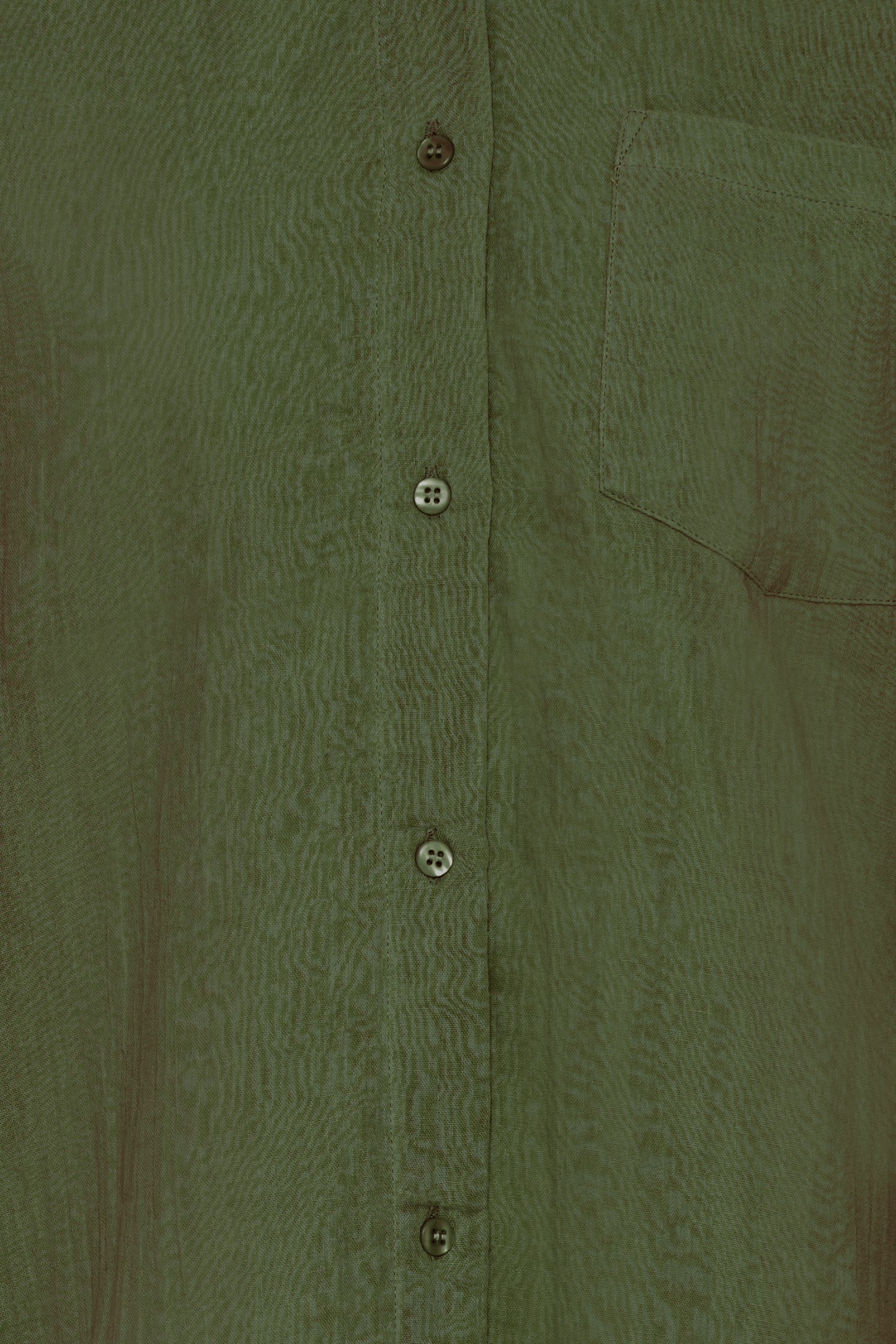 Close-up of a green textured shirt with buttons