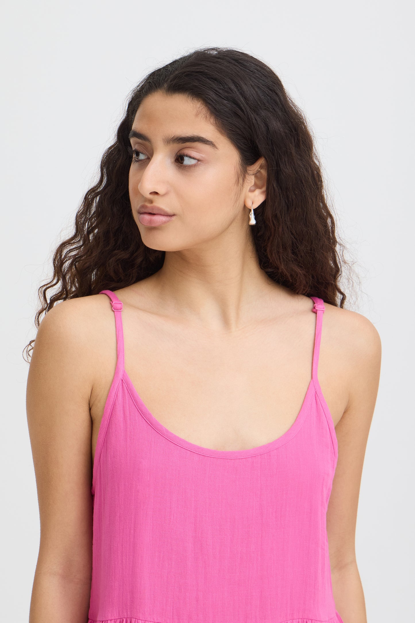 Woman wearing a pink dress against a white background