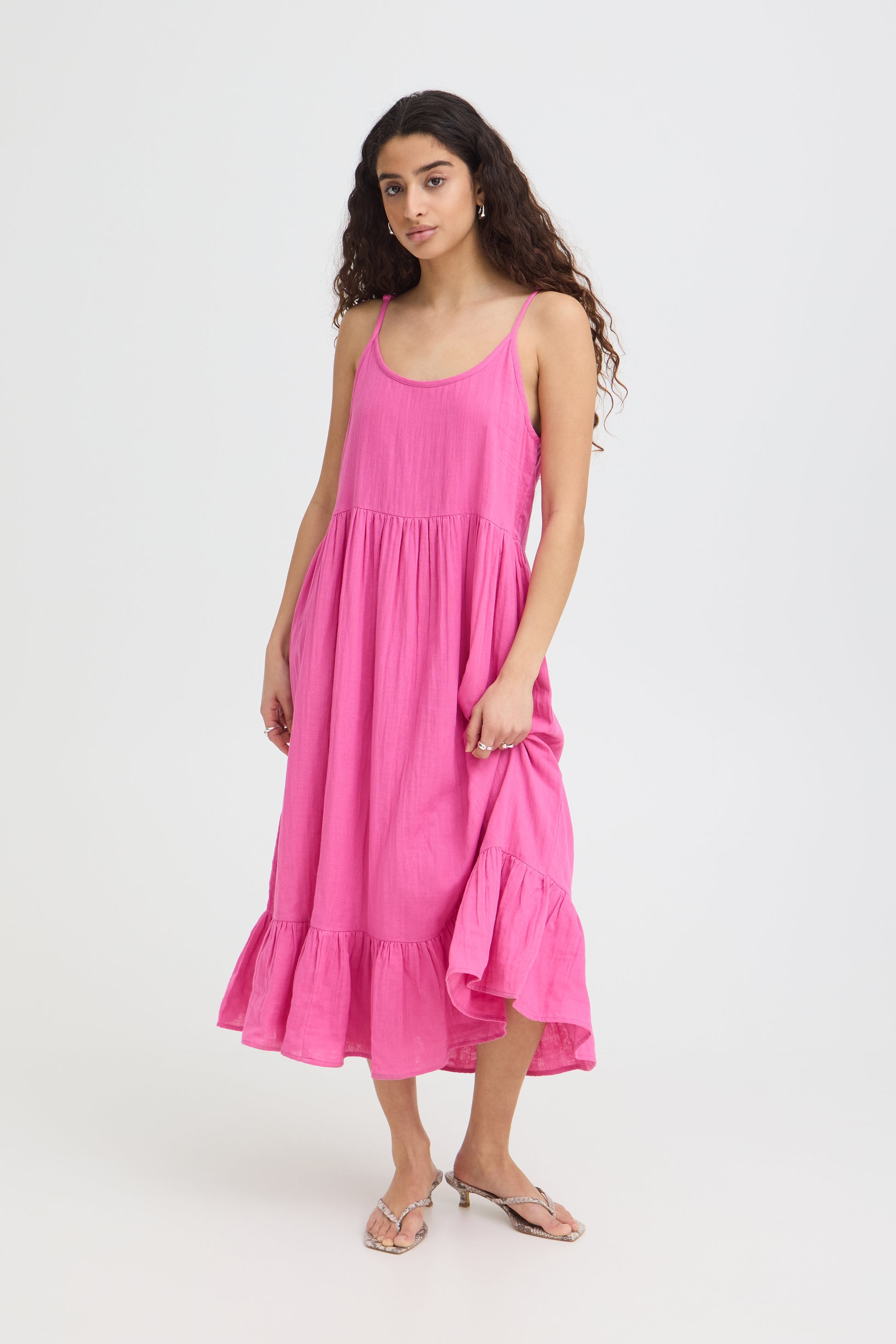 Woman wearing a pink dress on a white background