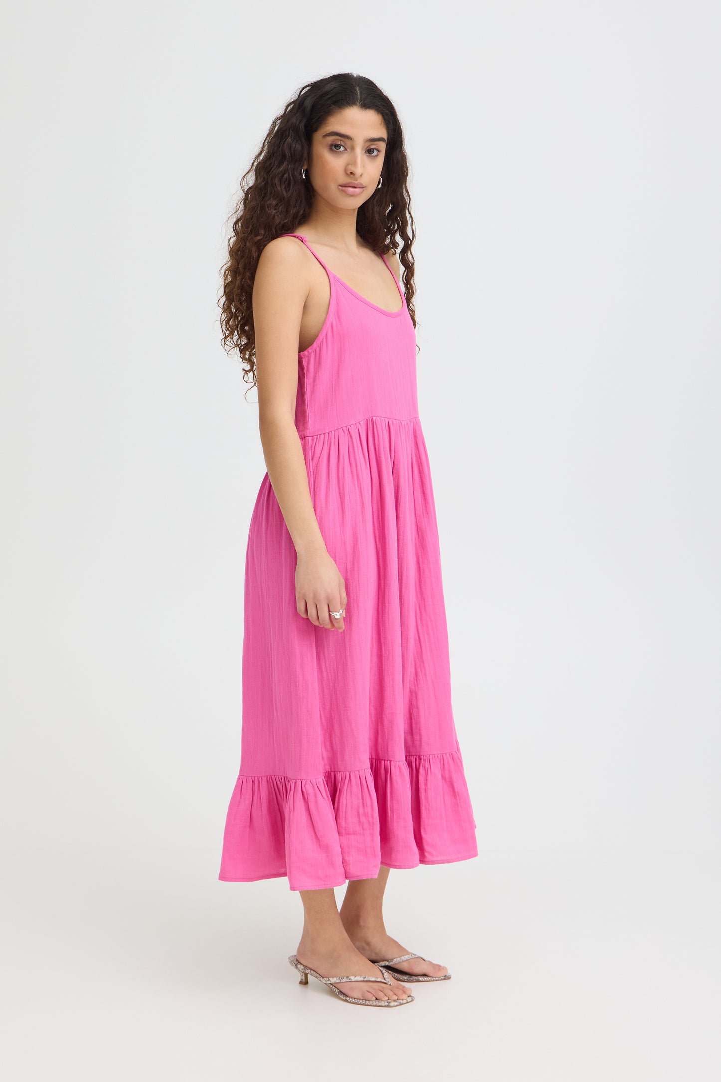 Woman wearing a pink dress on a white background