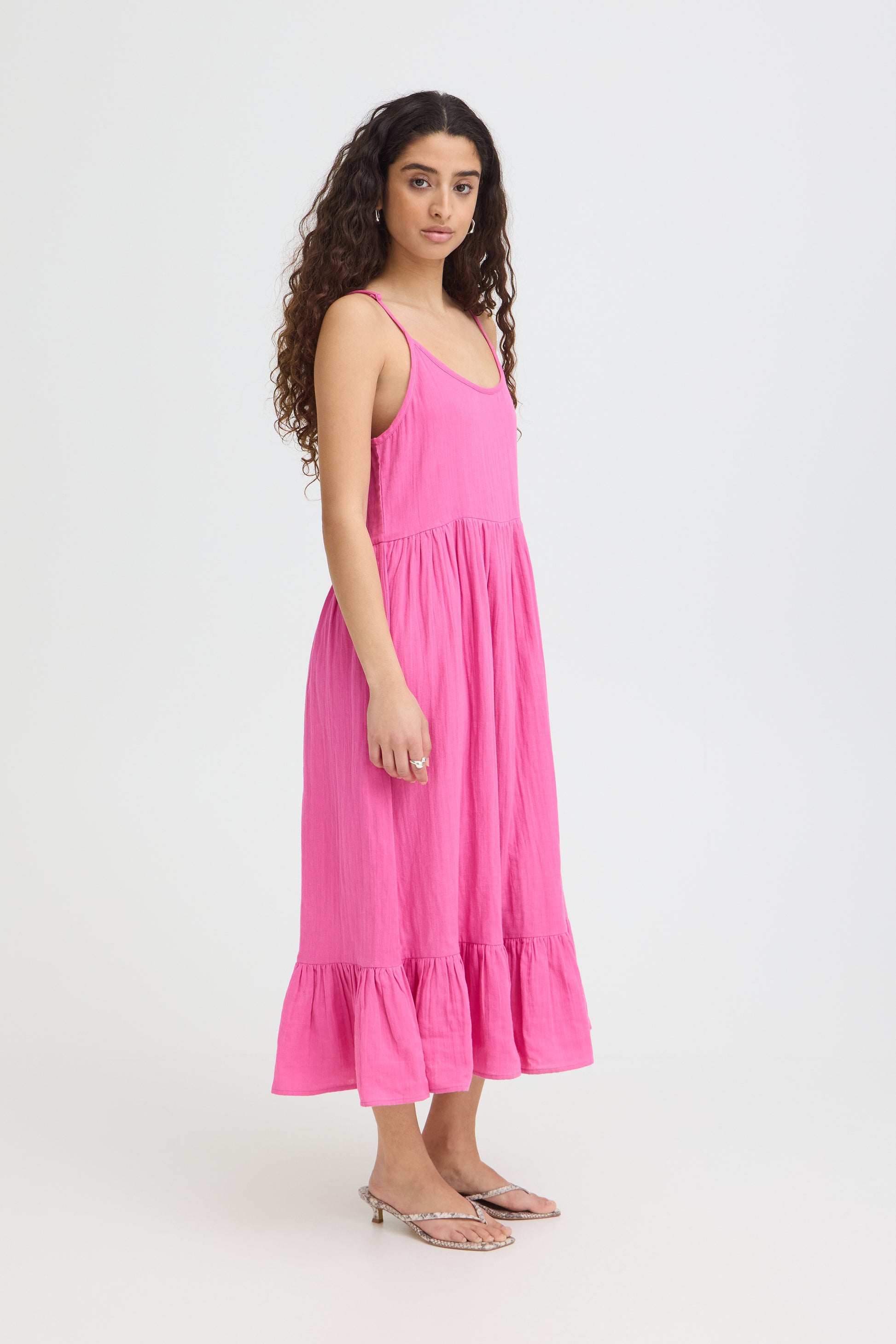 Woman wearing a pink dress on a white background