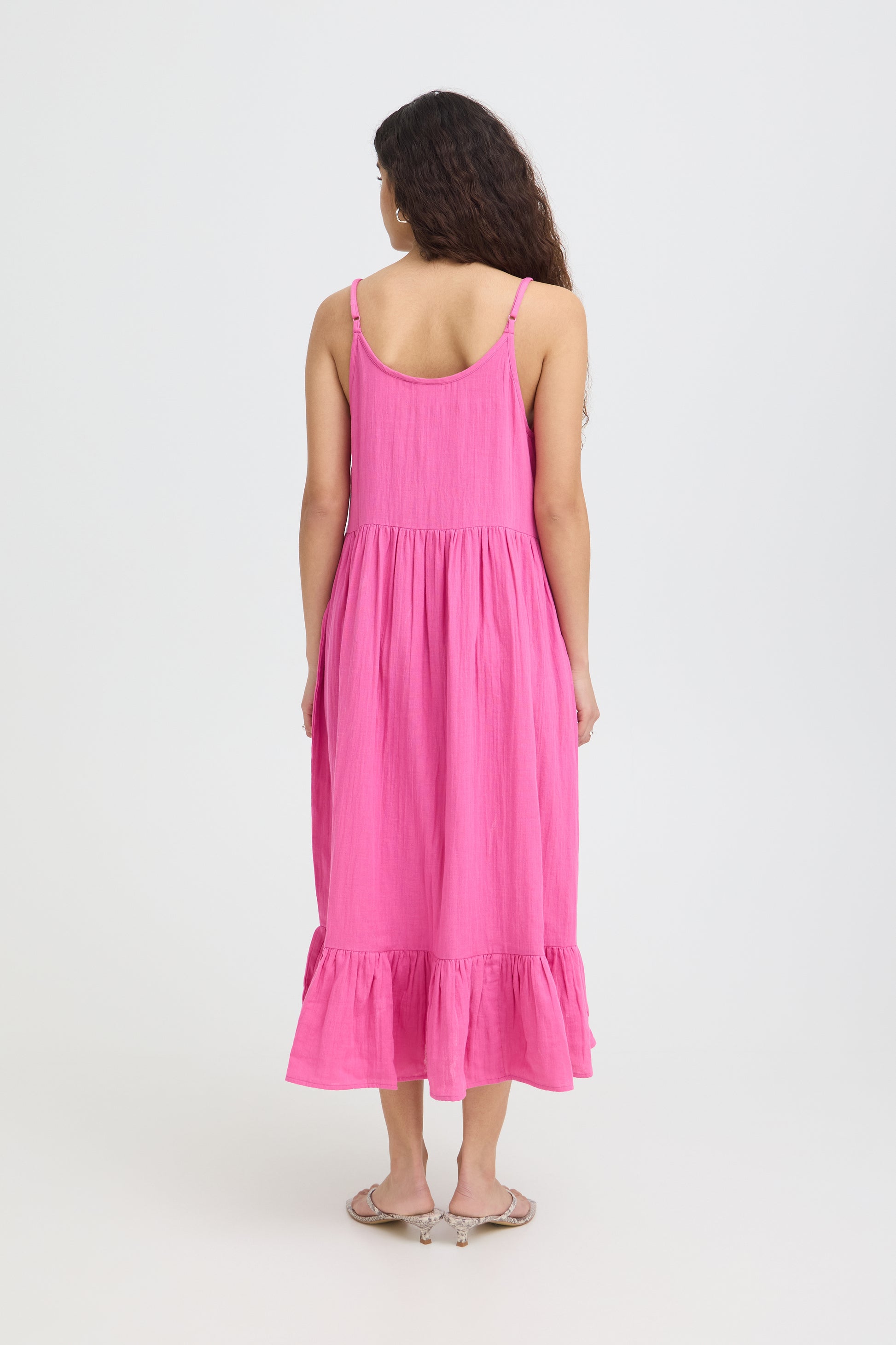 Woman wearing a pink dress on a white background