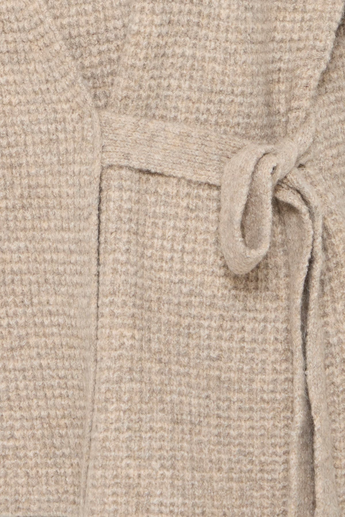 Close-up of a beige textured fabric with a drawstring