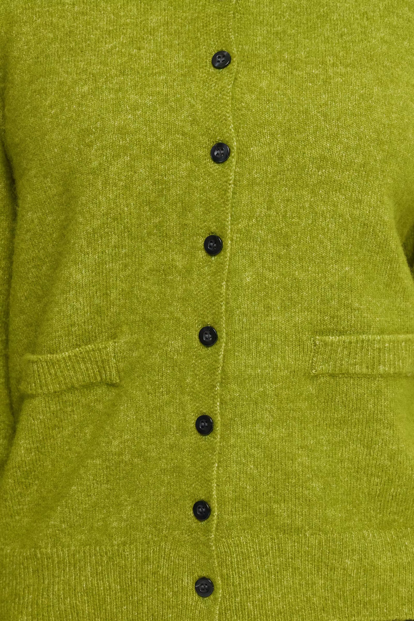 Close-up of a textured olive green knit cardigan featuring a vertical row of black buttons down the center front and ribbed trim.